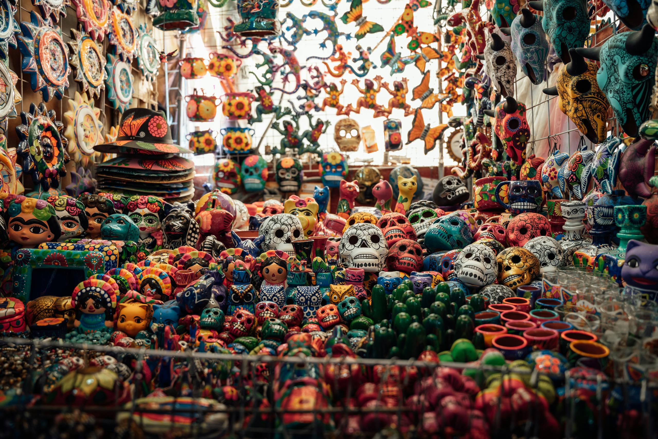 Colorful ceramic skulls and crafts at a market in Ciudad de México, showcasing Mexican culture.